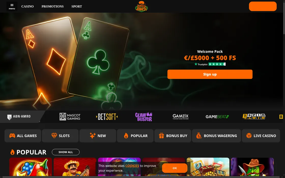 Hidden Jack’s homepage as captured: its top-hat logo over the Casino, Promotions and Sport menu, a welcome-pack banner beside two glowing playing cards, a row of game-studio logos, game category buttons and a cookie notice